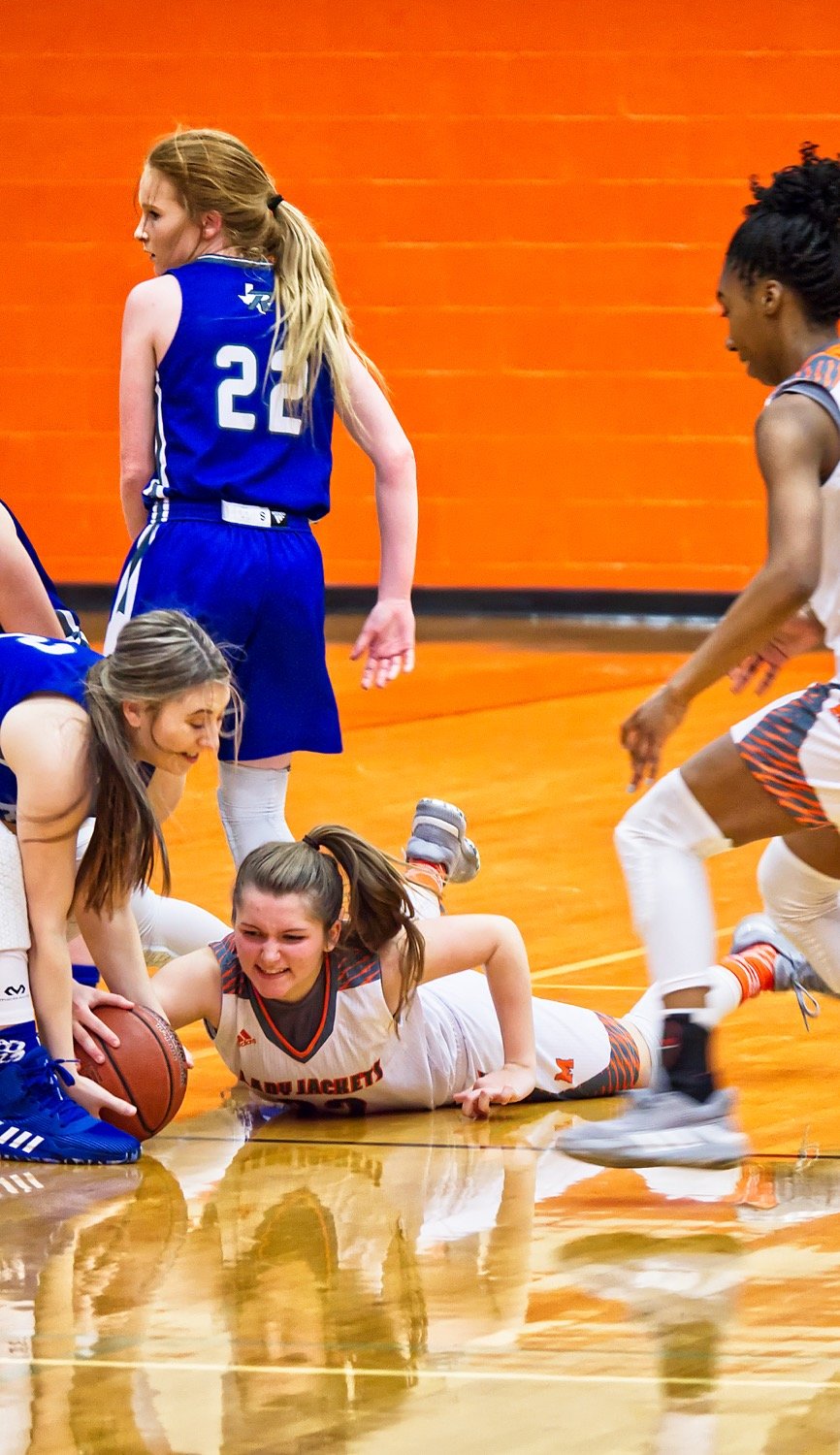 Cyndi Butler gets on the ground to track down a loose ball.